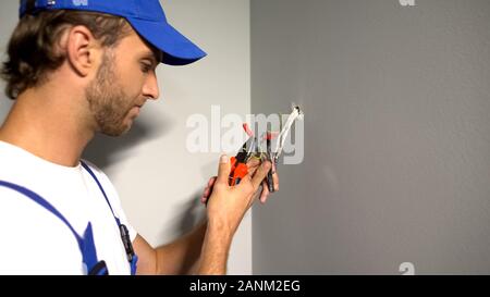 Heimwerker Kabel abisolieren, Entfernen der Isolierung mit einer Zange, elektrische Dienstleistungen Stockfoto