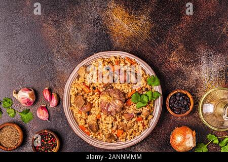Pilav mit Fleisch, Gemüse und Gewürzen, Ansicht von oben. Stockfoto