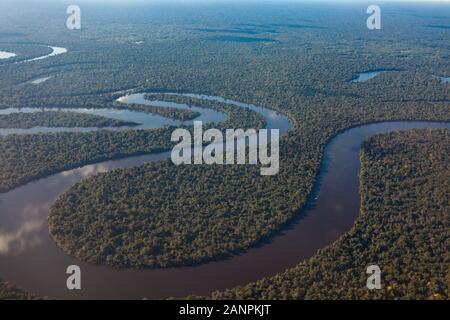 Blick auf den Fluss Amazonas vom Flugzeug aus, dichten tropischen Wald, Spiegelbild im Wasser. Stockfoto