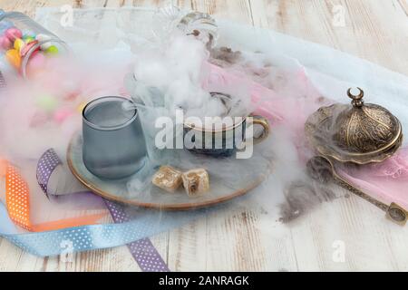 Traditionellen türkischen Kaffee in Porzellan Schale setzen, ein Glas Wasser und türkischem Honig, bunte Mandel Bonbons auf der Oberfläche mit Kaffeebohnen. Ein Fest (f Stockfoto