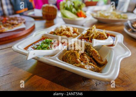 Nahaufnahme der Würzigen Wurst In Scheiben aus Nordthailand mit verschiedenen würzigen Pasten aus Nordthailand. Stockfoto