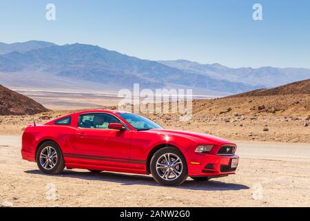 Death Valley, Kalifornien, USA - 02. Juni 2015: Roter Ford Mustang auf den Künstler Dr. Wüste Salzsee im Hintergrund. Stockfoto