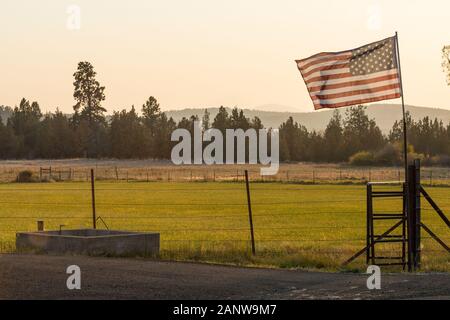 Sonnenuntergang Licht durch eine wehende US-Flagge in der Nähe von Terrebonne Stockfoto