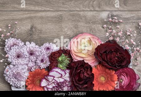 Bunte Blume Anordnung auf Holz- Hintergrund. Flach, Ansicht von oben mit der Kopie Raum- und Gemeinkosten. Konzept für Muttertag, Valentinstag, Geburtstag Stockfoto