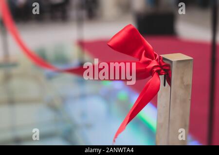 Prozess der Schneiden das Red Ribbon während der Eröffnung des neuen Einkaufszentrum mall Gebäude, Eröffnung der Ausstellung, in der Nähe der roten ribbo Stockfoto