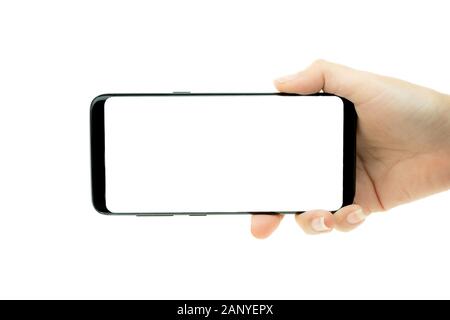 Frau Hand schwarz Handy mit weißer Bildschirm im Hintergrund, Smartphone leerer Bildschirm Stockfoto