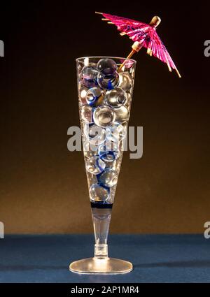 A Champagne flute filled with water retaining beads that look like spherical ice cubes - cool drinks. Stockfoto