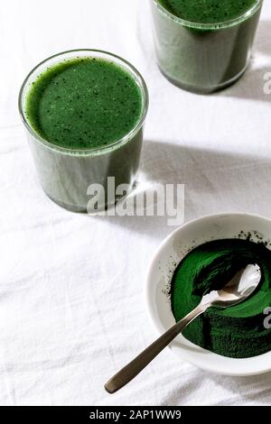 Farbe grün Spinat kale apfeljoghurt Smoothie mit Spirulina auf weißem Hintergrund mit Schatten Close-up.Detox, Superfood, Diät, gesund Stockfoto