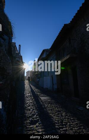 Lady klettern gepflasterten Straße Sonnenuntergang in Monsanto Portugal Stockfoto