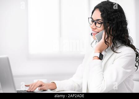 Smiling hispanic Geschäftsfrau Gespräch am Handy Stockfoto