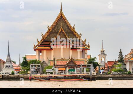 Boot vertäut an der Pier außerhalb Wat Kalayanamitr Varamahavihara auf dem Chao Phraya River, Bangkok, Thailand Stockfoto