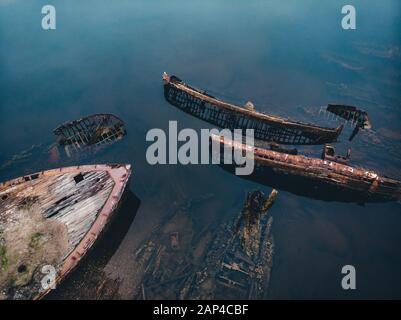 Friedhof der alten Schiffe Teriberka Murmansk Russland, Holz- bleibt der industriellen Fischerboote in Meer. Industrialisierung Konzept. Antenne Top View Stockfoto