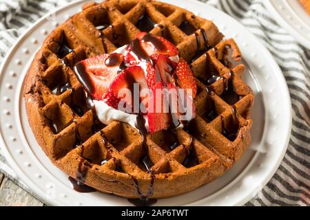 Hausgemachte dunkle Schokolade Waffeln mit Sahne und Erdbeeren Stockfoto
