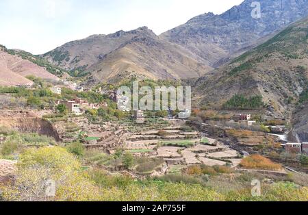 Blick auf das Dorf Tamatert im marokkanischen Atlasgebirge, das im Tal nahe dem Berg Toubkal liegt, mit abgestuften Feldterrassen Stockfoto