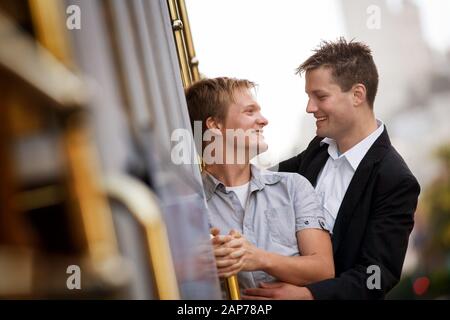 Zwei junge homosexuelle Männer lächeln miteinander. Stockfoto