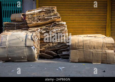 Stapel von abgeflachten Kartonschachteln sind gebündelt und bereit für das Recycling. In Kalkutta (Kalkutta), Indien. Stockfoto