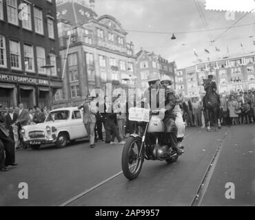 Dam tot Dam Race, First Day, [Motorradfahrer mit Passagier, AVRO bei Hilversum] Anmerkung: Am 27. August 1959 wurde das allererste DAMEN-RENNEN ausgetragen. Die Veranstaltung war eine Initiative der Gemeinden Amsterdam und Zaandam als spielerischer Protest gegen die fehlende Verbindung zwischen Amsterdam und Zaandam. Sie wollten Druck auf die Regierung ausüben, um den Coentunnel schnell zu realisieren. Die Teilnehmer mussten eine Route von der Zaanse Dam zum Amsterdamer Dam nehmen, auf der alle möglichen Schiffe und Schiffe erlaubt waren. Viele prominente Persönlichkeiten nahmen an dem Rennen Teil, wie Sänger Teddy Scholten, Dichter S. Stockfoto