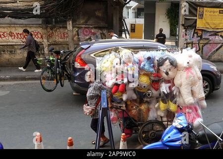 Bangkok, Thailand - 26. Dezember 2019: Frau zieht Wagen, wo viele gefüllte Spielzeuge sind. Stockfoto