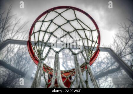 Selektive Fokussierung auf einen Basketballkorb. Bewölkter Tag. Lebhaft. Stockfoto