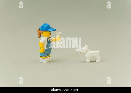 Florianopolis - Brasilien, 5. Mai 2019: LEGO-Miniaturen von stehenden Tamer, die ihren Hunden mit einem Knochen in der Hand beibringen. Trainer spielt mit Hunden. LEGO Min Stockfoto