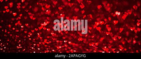 Abstraktes Licht, rotes Bokehmuster in Herzform. ST Valentines Day oder Holiday Concept, Hintergrundbanner. Stockfoto