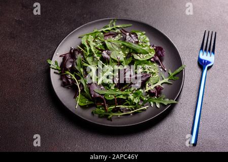 Gesundes Essen, Salatmischung mit Arugula, Spinat, Bullenblut, Rübenblättern und Mikrogrüns. Lebensmittelhintergrund, Kopierbereich Stockfoto