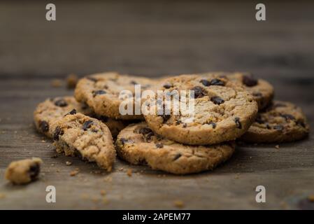 Klassische Schokoladenchip-Plätzchen vor Holzhintergrund. Stockfoto