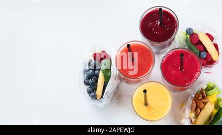 Htalthy frische Obst- und Gemüsesmoothies mit verschiedenen Zutaten in Packungen. Draufsicht mit Kopierbereich Stockfoto