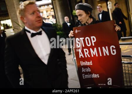 Anti-Waffenhandel-Aktivist hält einen Plakat während eines Protestes außerhalb des jährlichen Black-Tie-Dinner der Aerospace, Defence and Security Group im Grosvenor House Hotel an der Park Lane in London. Die ADS Group, eine in London ansässige Non-Profit-Handelsorganisation, vertritt und unterstützt mehr als 1.000 britische Unternehmen, die in der Luft- und Raumfahrt tätig sind. Verteidigungs- und Sicherheits- und Raumfahrtbereiche. Der Protest wurde von der Campaign Against Arms Trade (CAAT) und Stop The Arms Fair Pressure Groups unter Hinweis auf den Verkauf von Waffen und Munition aus Großbritannien an Saudi-Arabien, das weiterhin Houth streikt, aufgerufen Stockfoto