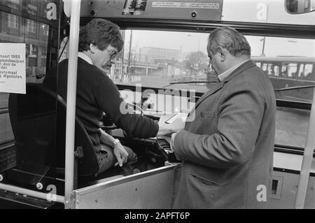 Busfahrer überprüft und stampft die Tickets statt der Stempelmaschine seit dem 3. April 1985 Datum: 5. März 1985 Schlagwörter: Busse, Fahrer Stockfoto