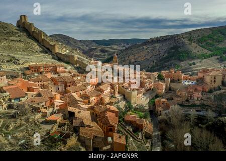 Luftpanorama-Blick auf Albarracin in Teruel Spanien, mit mittelalterlichen Häusern aus rotem Terrakotta aus rotem Sandstein, maurischer Burg und alten Stadtmauern gewählt am meisten B. Stockfoto