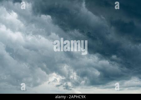 Gewitterwolke Hintergrund während regnen. Dunkle Wolken. Riesige schwarze Wolken am dunklen Himmel vor dem Gewitter. Stockfoto