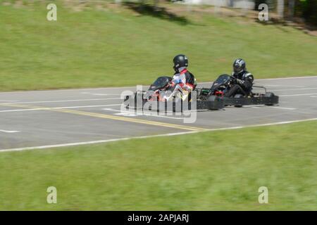 Florianopolis - Brasilien, 9. Februar 2019: Seitenansicht des dynamischen Bildes von zwei konkurrierenden, schnellen Gokarts mit Bewegungsunschärfe. Zuerst platziert Stockfoto