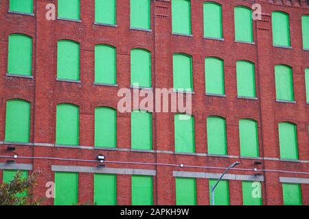 Die roten Ziegelsteine und die grünen Fenster in Brooklyn Stockfoto