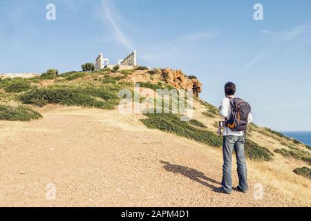 Tourost, der die alte Ruine des Poseidon Tempels, Kap Sounion, Attika, Griechenland betrachtet Stockfoto