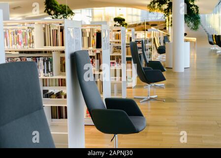 Helsinki, FINNLAND - 28. Dezember 2019: Zentralbibliothek Oodi in Helsinki - moderne Bibliothek. Innenbereich, Leseraum mit vielen Büchern und Stühlen Stockfoto