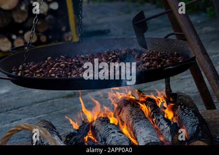 Beim Oktoberfest, das die Kastanienernte feiert, wird im toskanischen Bergdorf Gavinana bei einem offenen Feuer die Kastanienernte geröstet. Stockfoto