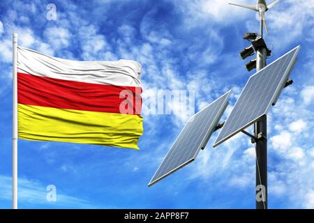 Sonnenkollektoren auf blauem Himmel mit Fahnenmast und Flagge Südossetiens Stockfoto