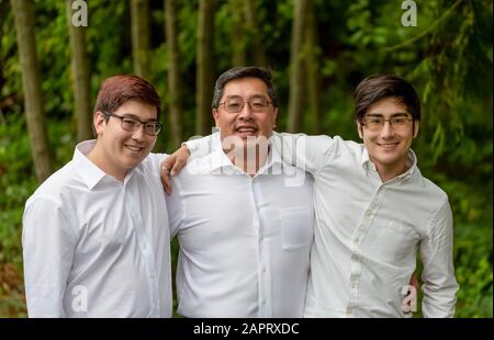 Ein Porträt eines Vaters mit zwei Söhnen, alle in weißen Hemden; Langley, British Columbia, Kanada Stockfoto