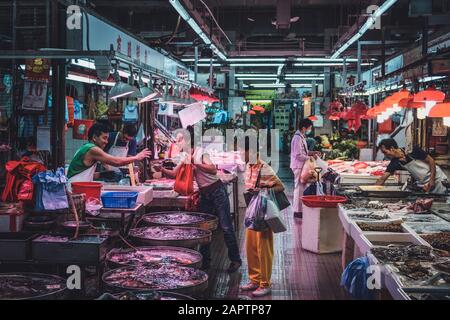 Hongkong - November 2019: Menschen kaufen und verkaufen Fisch auf dem Fischmarkt in Hongkong Stockfoto