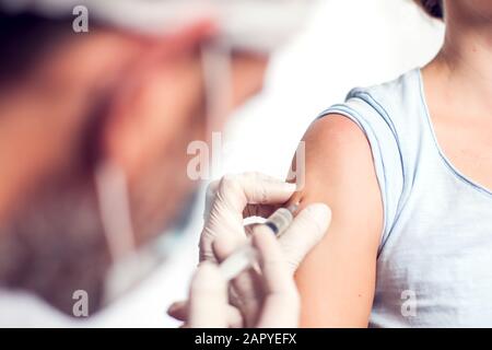 Ein Arzt, der den Patienten einspritzt. Isoliert. Nahaufnahme. Medizin- und Gesundheitskonzept Stockfoto