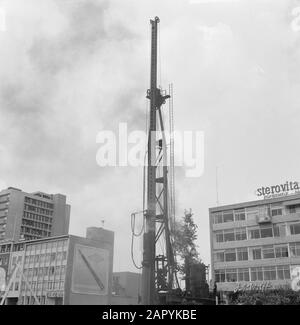 Proefheien für das Metrobau auf dem Hoeplein hoek Weena in Rotterdam, der 30 Meter hohe Haufen während der Plattenwand Datum: 8. August 1960 Standort: Rotterdam, Zuid-Holland Schlüsselwörter: Piling, Metrobuilding Stockfoto