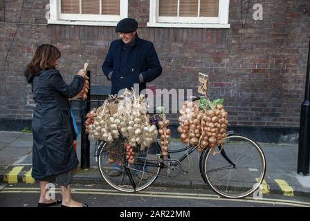 London, GROSSBRITANNIEN - 3. November 2007: Frau kauft Zwiebelschnur von einem französischen Zwiebelnynus Stockfoto