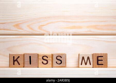 Der Satz Kiss Me. Kiss Me on Holzwürfel. Liebesthema. Valentinstag. Wood Letter blockiert mit Worten Kiss Me Love, positive Emotionen. Holzwürfel mit dem Satz Küssen Sie Mich Stockfoto