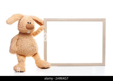 Ein gefülltes Kaninchen mit Holzrahmen auf weißem Grund. Kopierbereich. Stockfoto