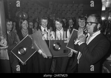 Popgroep The Shuffles erhält Goldplatte für Cha la, ich brauche Sie im Hotel Gooiland in Hilversum. The Shuffles with Record, right Joost den Draaier (Pseudonym für Willem van Kooten) Annotation: The Shuffles bestand aus Sänger Albert West (unten links), Bassist Hans van Liempt. Keyboarder Hans Sleutjes und Gitarrist Henk van den Heuvel. Links Manager Jan Vis Datate: 12. Februar 1970 Ort: Hilversum, Noord-Holland Schlüsselwörter: Disc-Jockeys, Grammophon-Platten, Musik, Popgruppen, Preise persönlicher Name: Draaier, Joost den, Koosten, Willem van, Shuffles, The Stockfoto