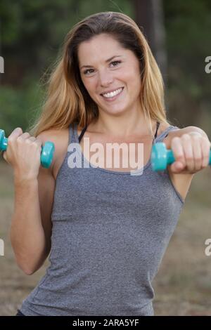 Frau, die im Freien mit Hanteln trainiert Stockfoto