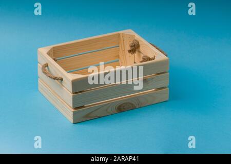 Holzkiste auf blauem Hintergrund. Nahaufnahme Stockfoto