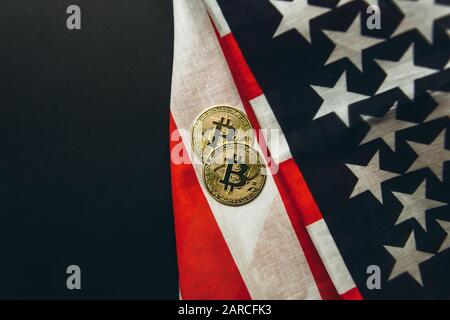 Bitcoin Cryptocurrency Münzen neben amerikanischem Flaggenhintergrund. Stockfoto