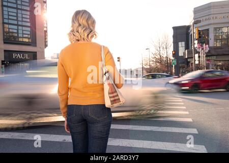 USA Maryland Bethesda Fußgängerin Sicherheit Frau Kreuzung in einem Querswalk mit Autoverkehr Stockfoto